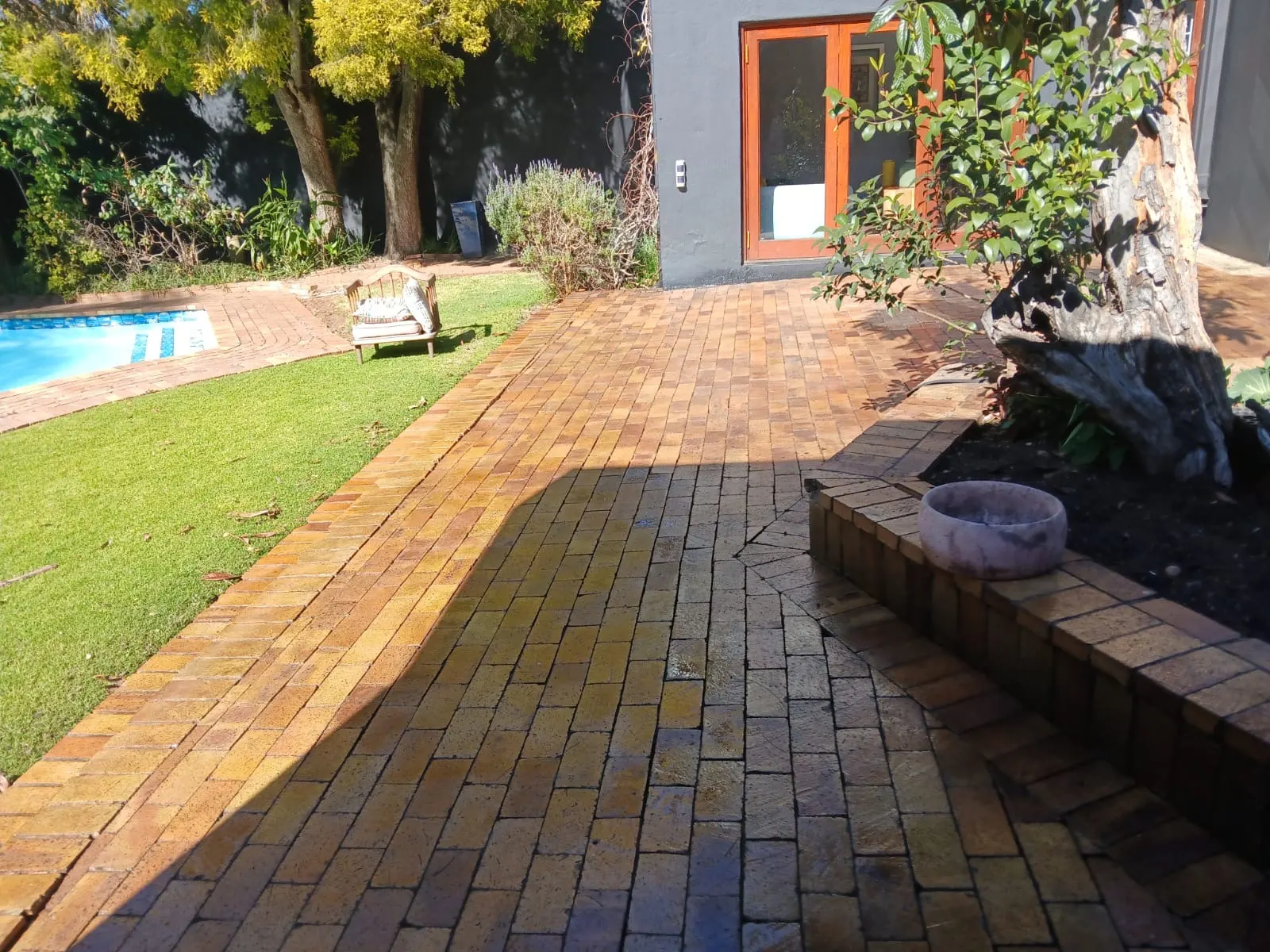 Restored brick paving pathway next to pool — garden paving project in Johannesburg
