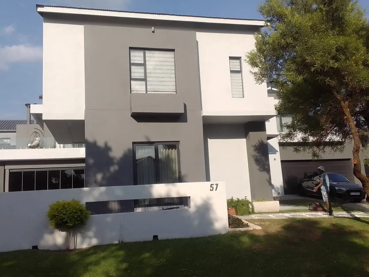 Modern double-storey house painted in two shades of grey