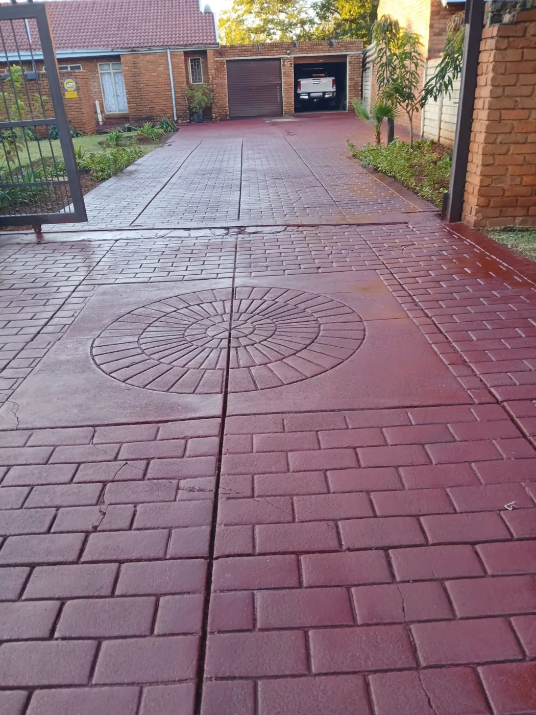 Stamped-concrete driveway painted red