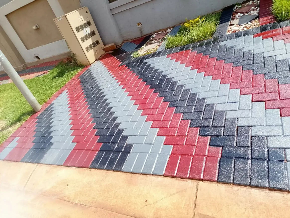 Herringbone paving painted in red, charcoal and grey chevrons