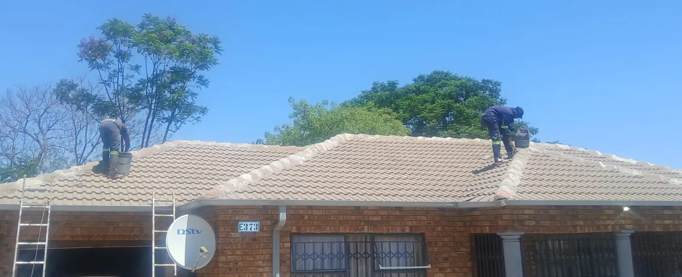 K-Son painters working on a tiled roof